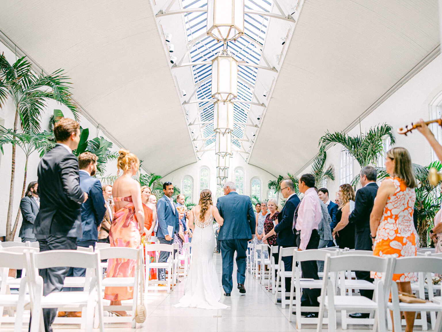 Bride walking down the aisle with her father at Piper Palm House, Tower Grove Park, Saint Louis, Missouri, during an unplugged ceremony, captured by James Tananan, wedding photographer and videographer.