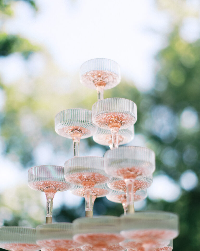 Champagne tower made of coupe glasses at a wedding reception