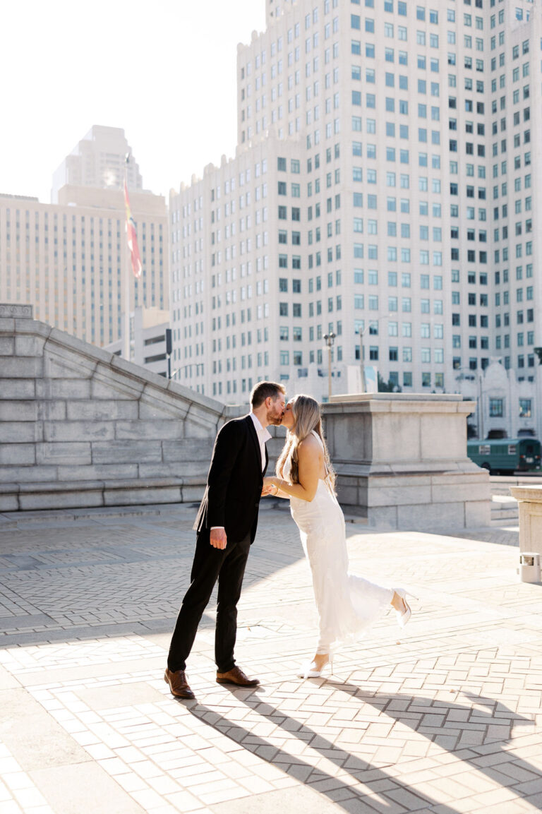 Engaged couple kissing near the Saint Louis Public Library in St. Louis